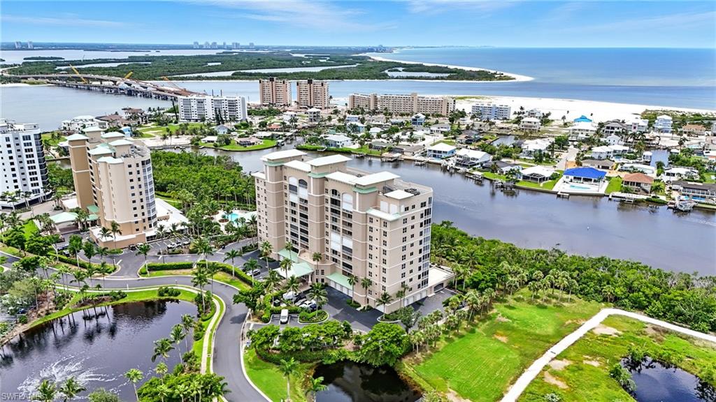 View of urban area with a large body of water and apartment complex / building - Virtually Edited Image