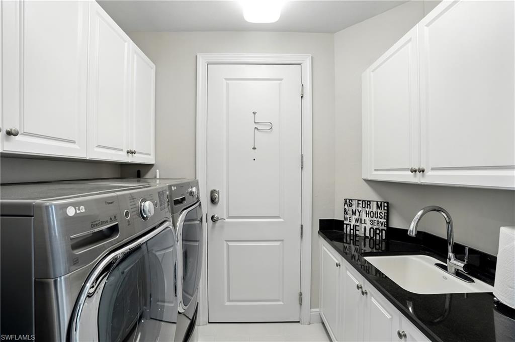 Laundry room with cabinet space and independent washer and dryer - Virtually Edited Image