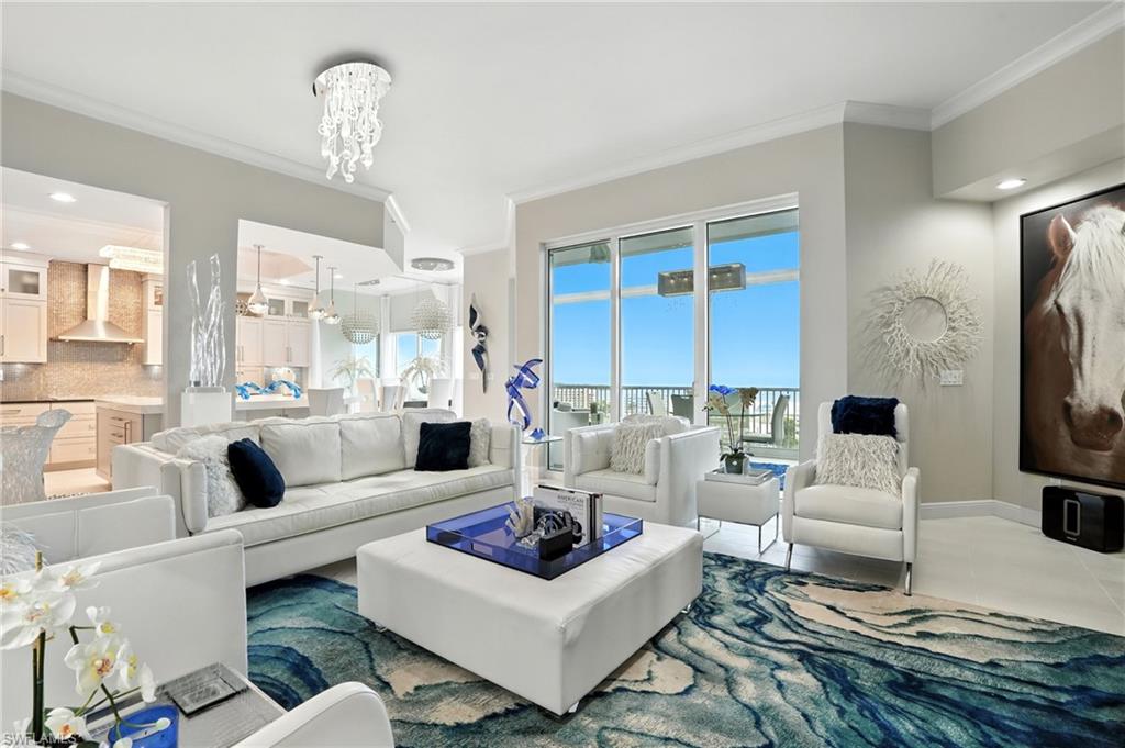 Living room featuring ornamental molding, recessed lighting, a chandelier, tile patterned flooring, and a wall unit AC - Virtually Edited Image
