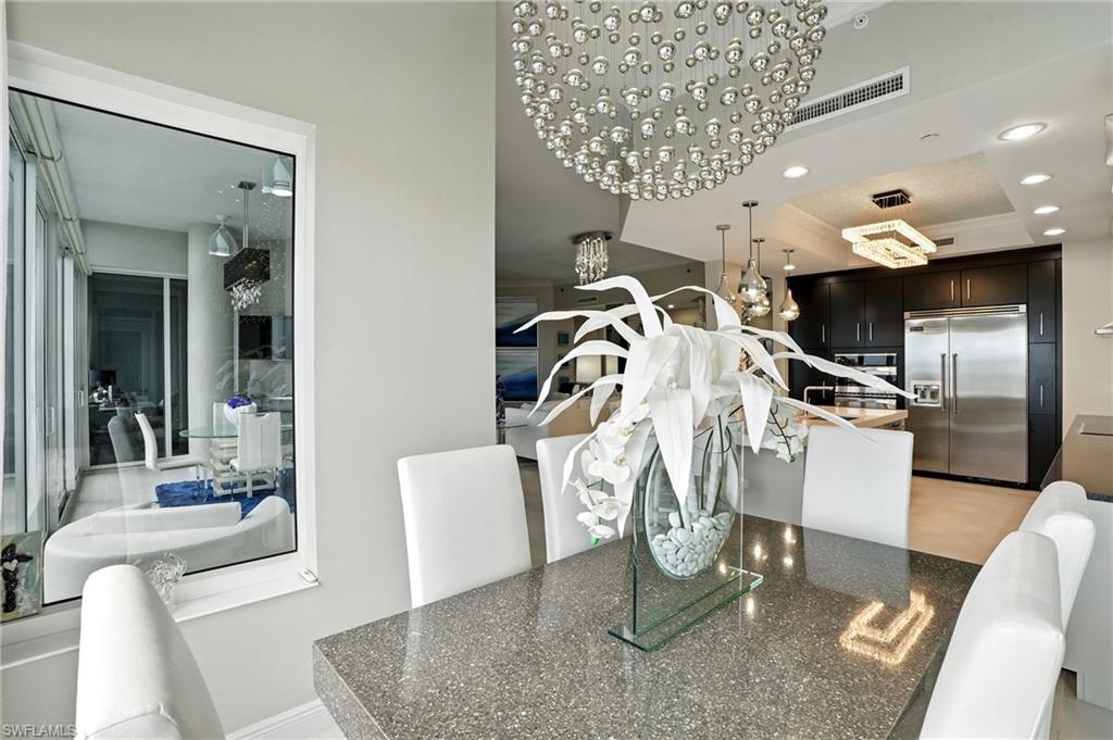 Dining room with recessed lighting and a tray ceiling - Virtually Edited Image