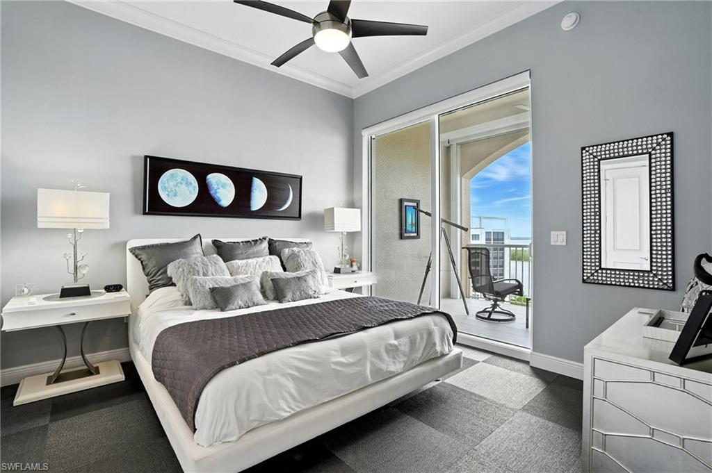 Bedroom featuring ornamental molding, a ceiling fan, and access to exterior - Virtually Edited Image