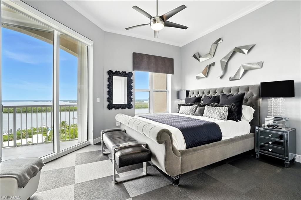 Bedroom with a water view, crown molding, access to exterior, and a ceiling fan - Virtually Edited Image