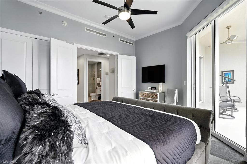 Carpeted bedroom featuring ornamental molding, access to exterior, and ceiling fan - Virtually Edited Image