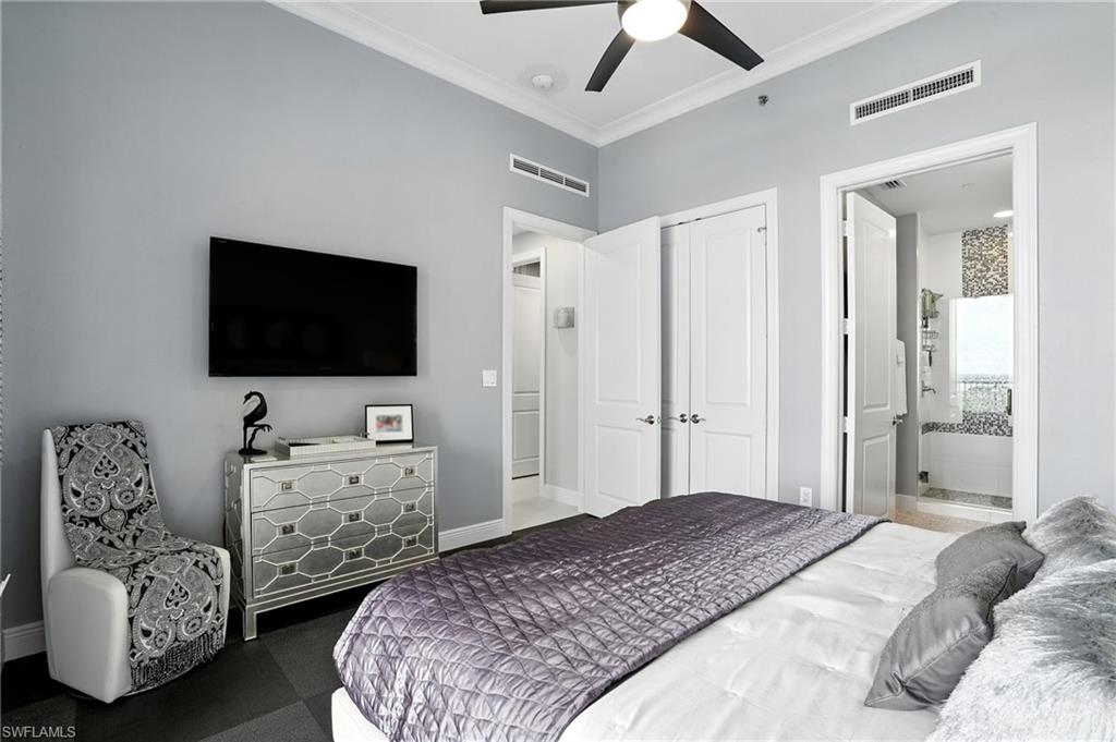 Bedroom with ornamental molding, ensuite bathroom, and a ceiling fan - Virtually Edited Image
