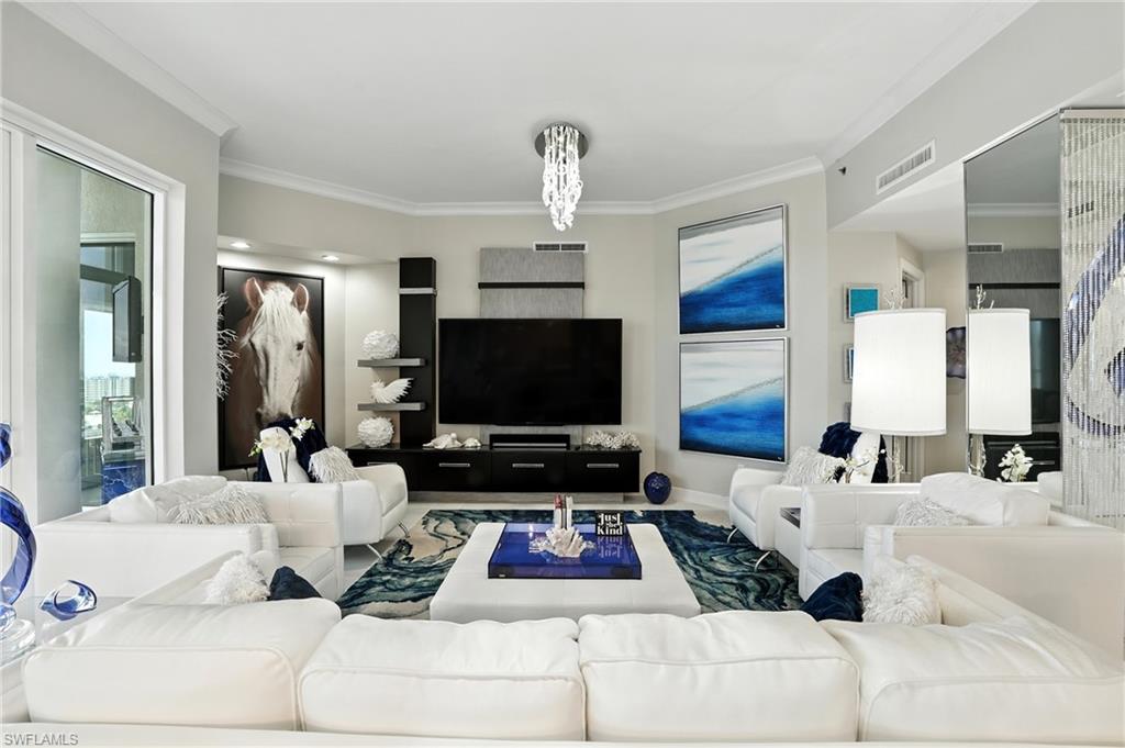 Living room featuring crown molding and plenty of natural light - Virtually Edited Image
