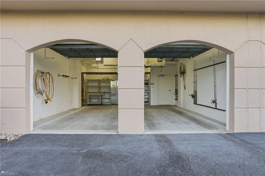 Garage featuring freestanding refrigerator and driveway - Virtually Edited Image
