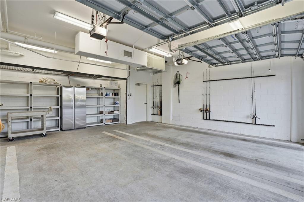 Garage with freestanding refrigerator and a garage door opener - Virtually Edited Image