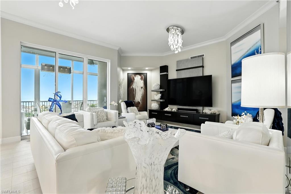 Living area with crown molding and a chandelier - Virtually Edited Image