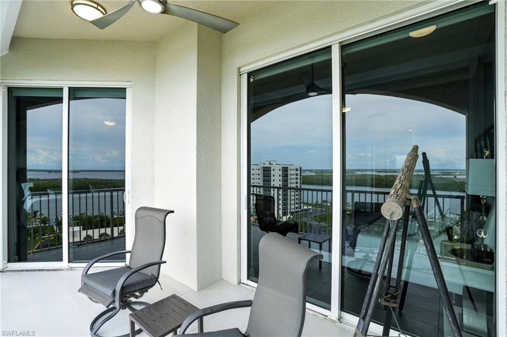 Balcony featuring a water view and a ceiling fan - Virtually Edited Image