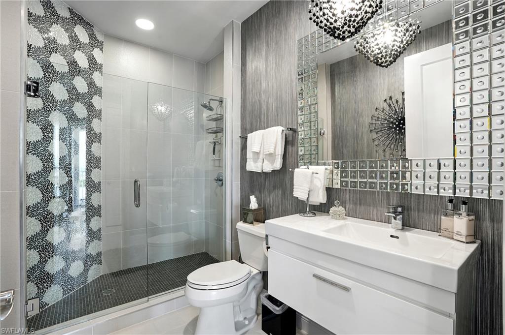 Full bath featuring vanity, a shower stall, and tile patterned flooring - Virtually Edited Image