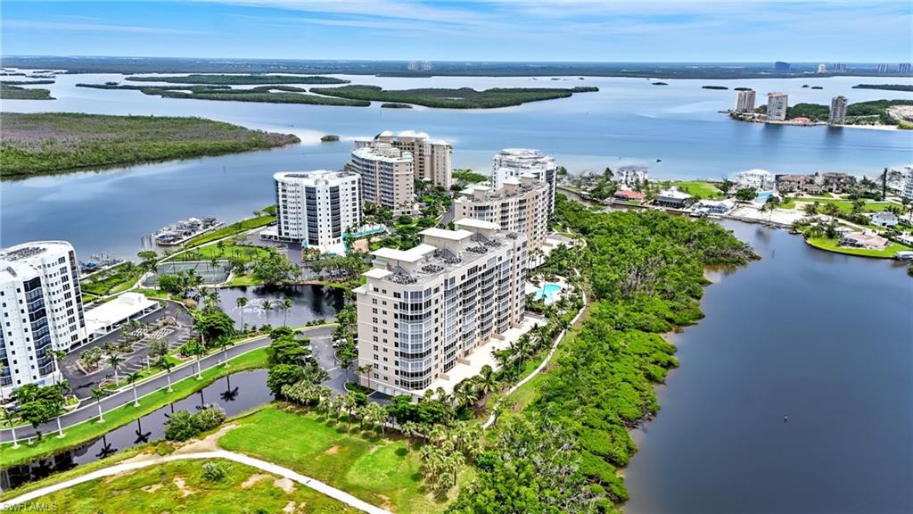 View of urban area with apartment complex / building and a large body of water - Virtually Edited Image