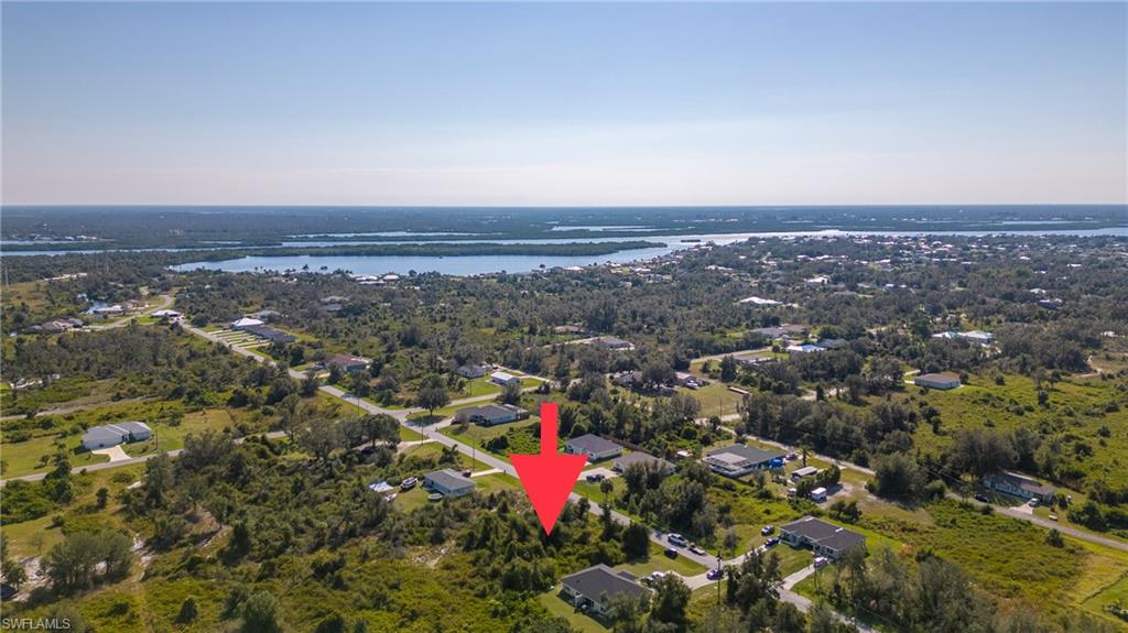 Aerial overview of property's location with a nearby body of water