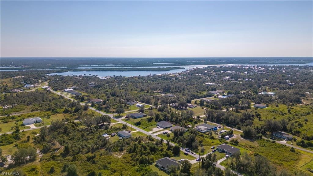 Aerial view of property's location featuring a nearby body of water