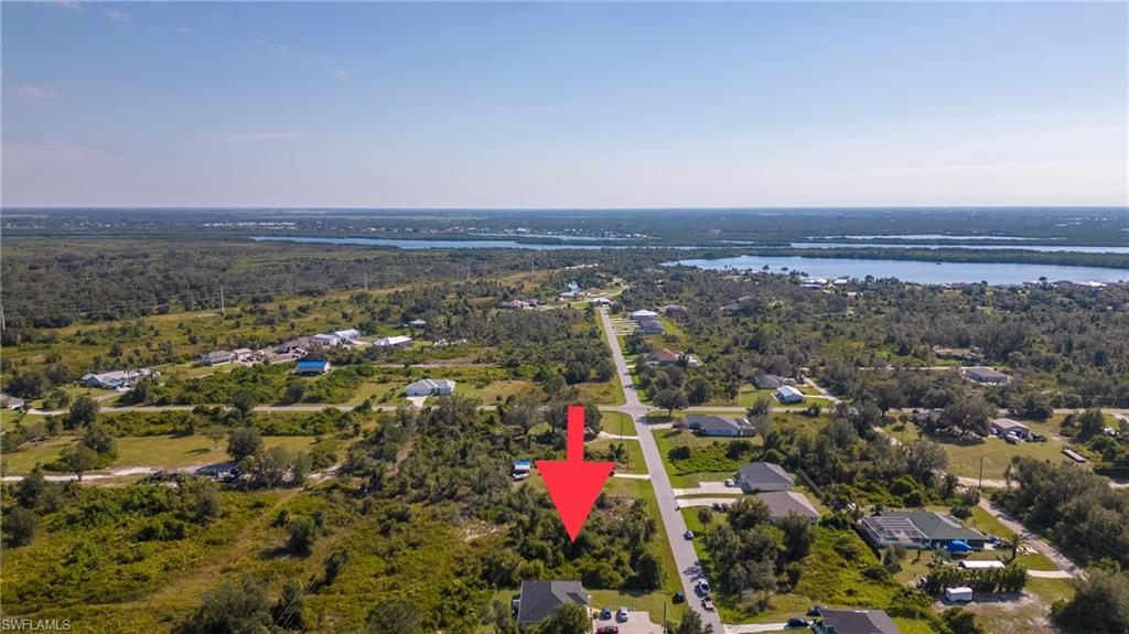 Aerial overview of property's location with a nearby body of water and nearby suburban area