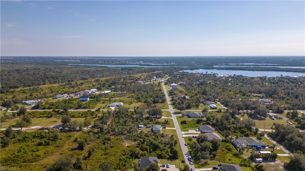 Aerial overview of property's location featuring a large body of water and nearby suburban area