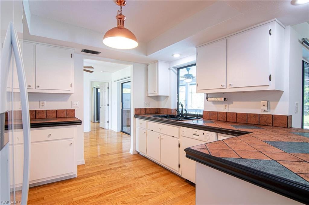 View from kitchen to formal dining area and primary suite beyond.