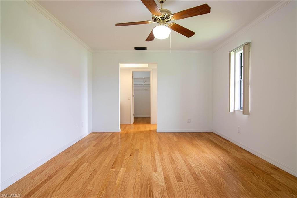 Primary bedroom view to ensuite bath and walk-in closet.