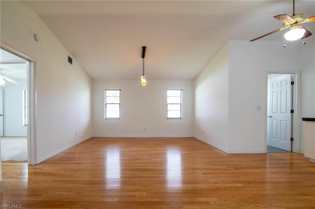Long view of the family room with guest bedrooms/bath to the left and laundry room entrance to the right.