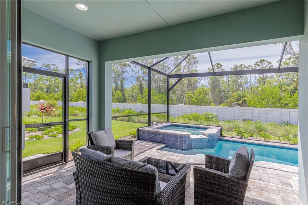 Sunroom with a hot tub