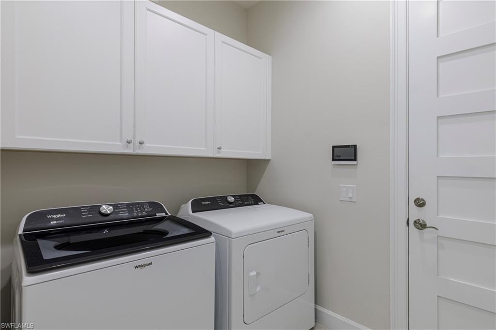 Laundry room with washing machine and clothes dryer and cabinet space