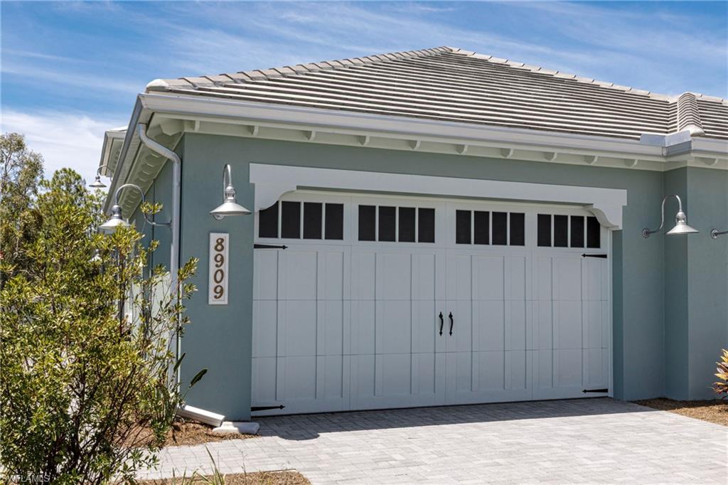 Garage featuring decorative driveway