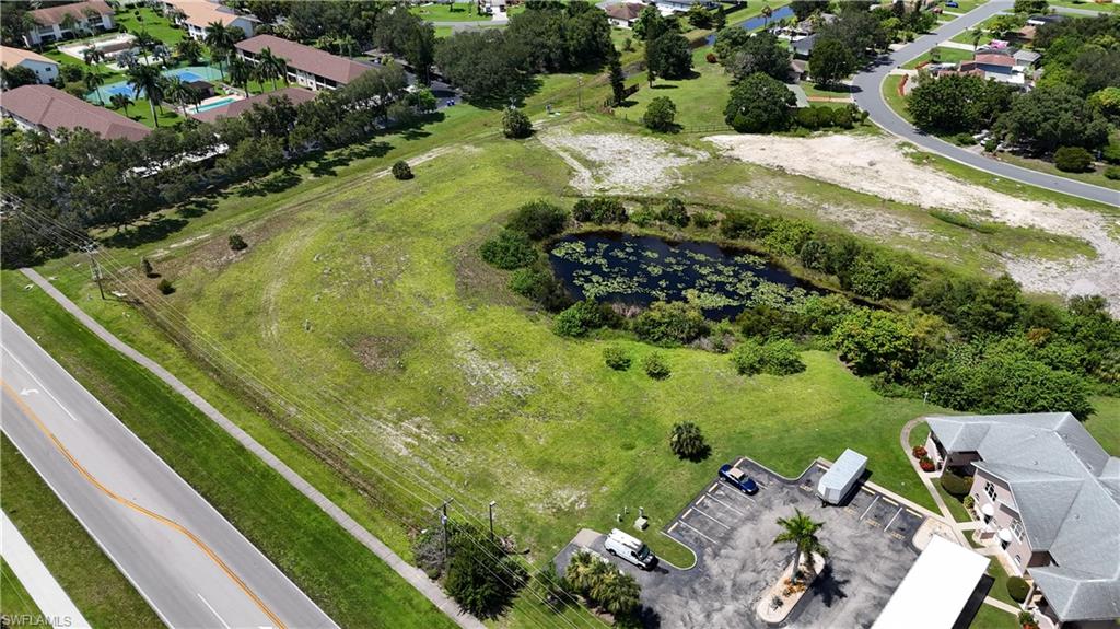 View of property location featuring a large body of water and nearby suburban area