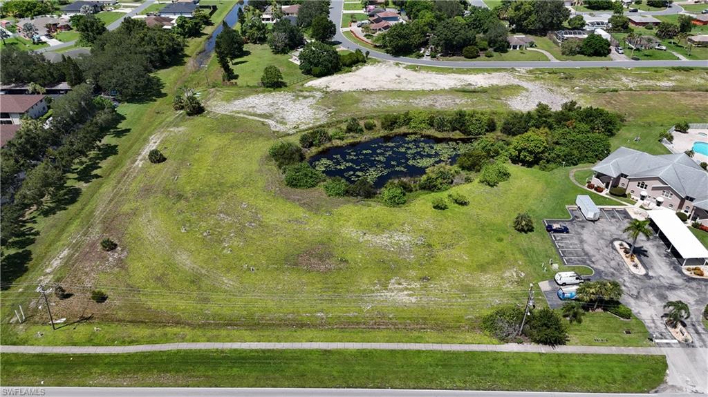 View of property location featuring a large body of water and nearby suburban area