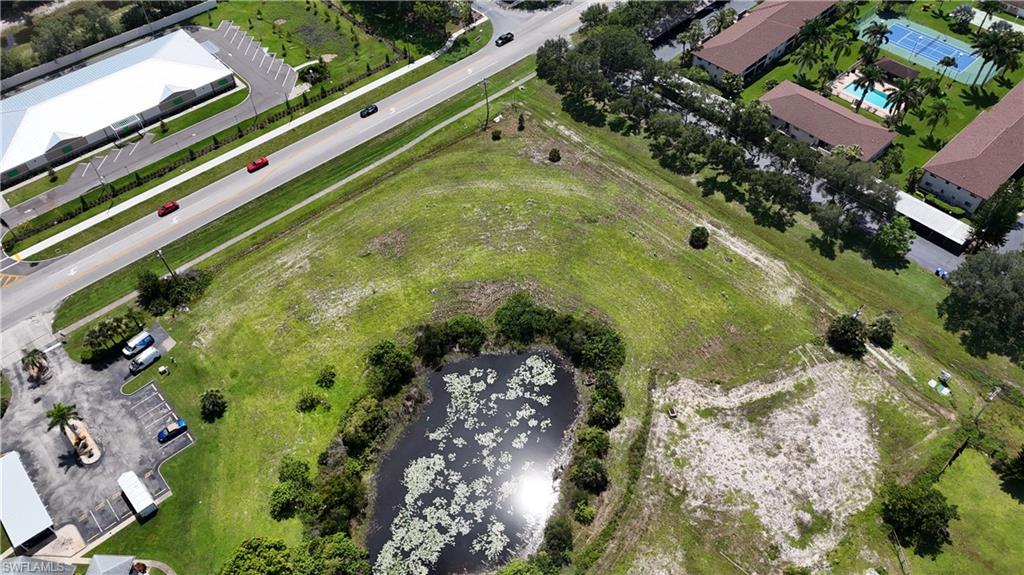 Aerial view of property and surrounding area featuring a nearby body of water