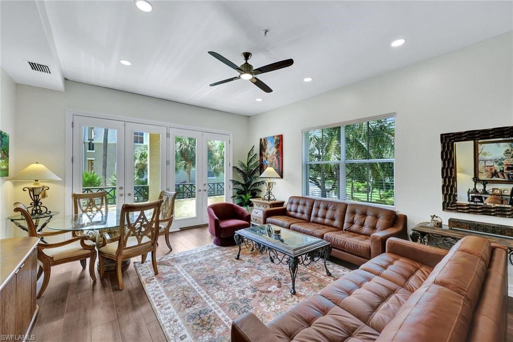 Living area featuring french doors, ceiling fan, wood-type flooring, and recessed lighting