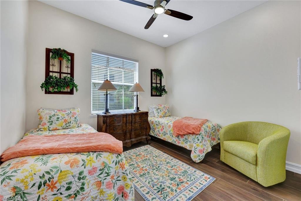 Bedroom featuring wood finished floors, ceiling fan, and recessed lighting
