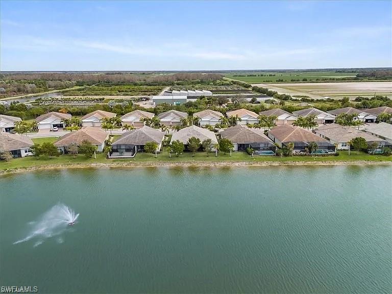Aerial view of residential area featuring a nearby body of water