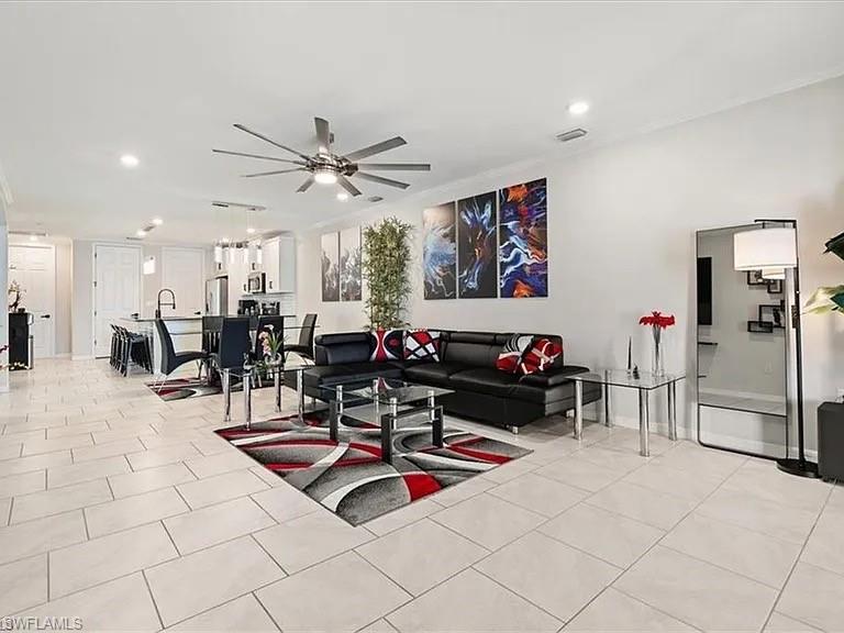 Living room with recessed lighting, light tile patterned floors, and a ceiling fan