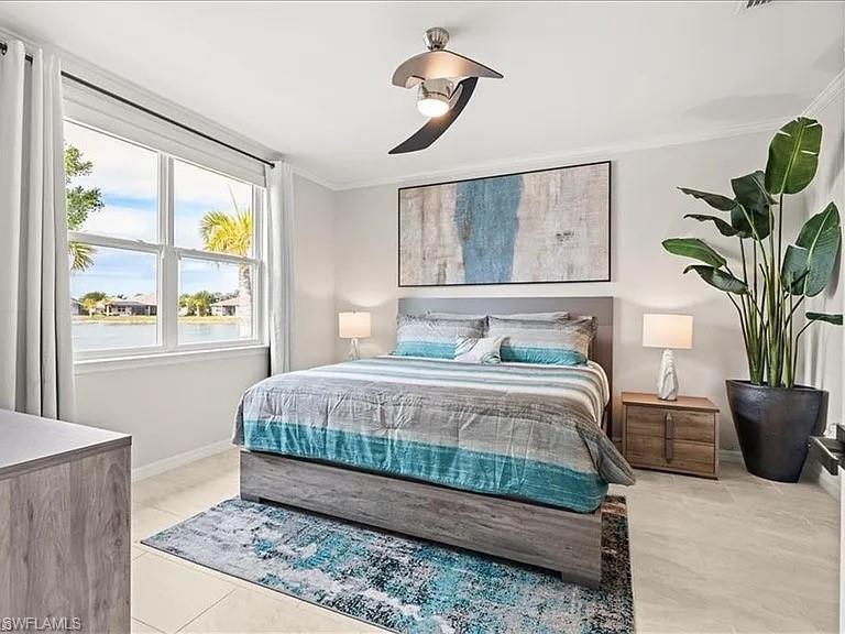 Bedroom featuring crown molding, ceiling fan, and light tile patterned floors