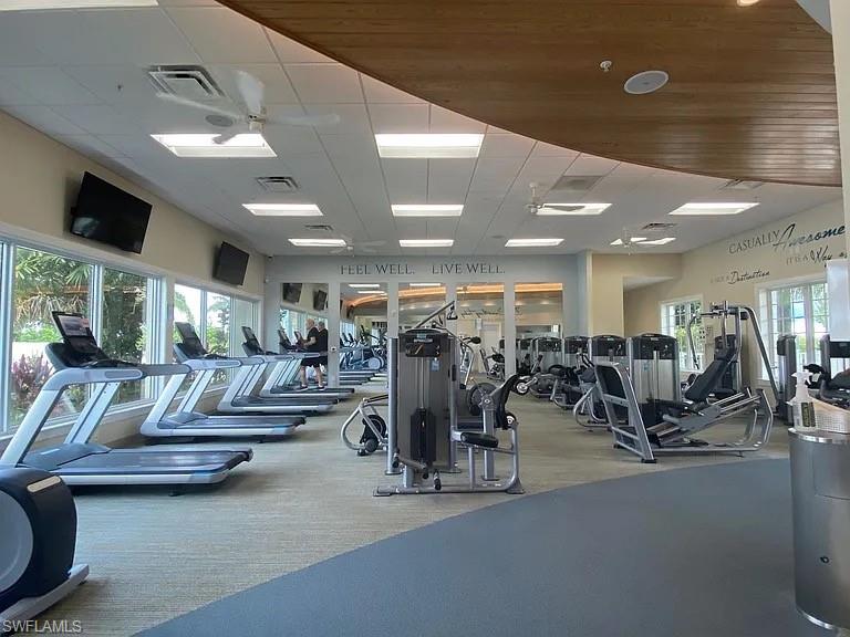 Gym featuring a paneled ceiling and carpet flooring