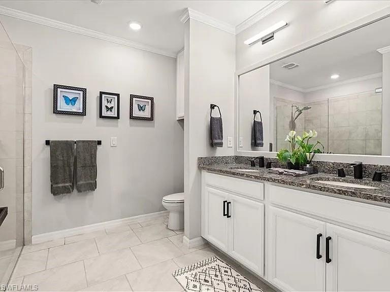 Bathroom featuring double vanity, a shower stall, ornamental molding, light tile patterned flooring, and recessed lighting