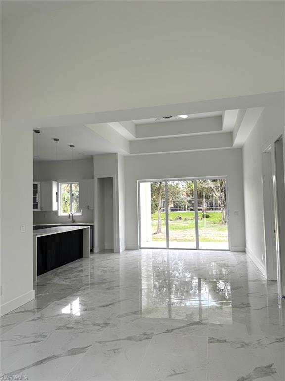 Kitchen with light marble finish flooring, light stone countertops, stainless steel appliances, glass insert cabinets, and gray cabinets
