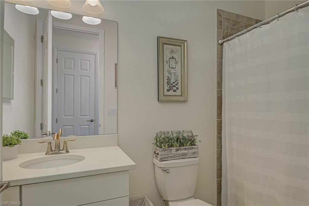Bathroom featuring vanity and curtained shower