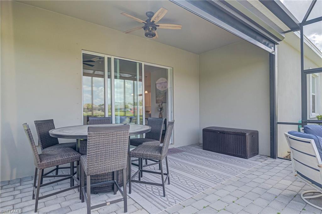 View of patio featuring outdoor dining space and ceiling fan