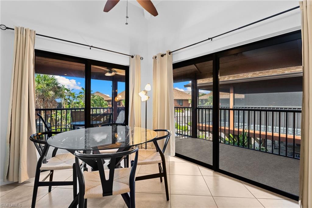 Dining room featuring a sunroom, light tile patterned floors, and a ceiling fan