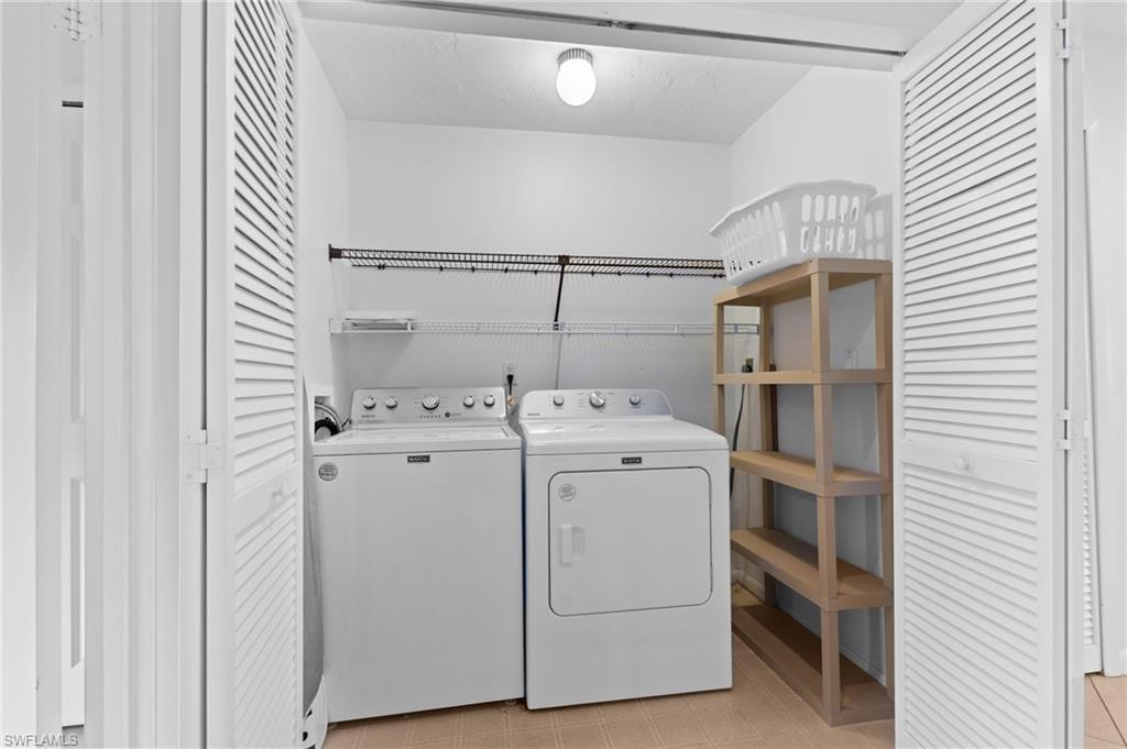 Washroom with washer and clothes dryer