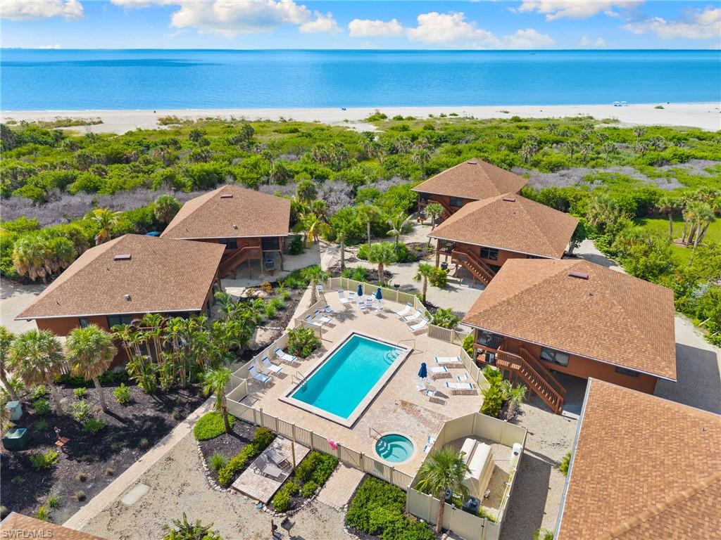 Drone / aerial view of a pool area and extended coastline