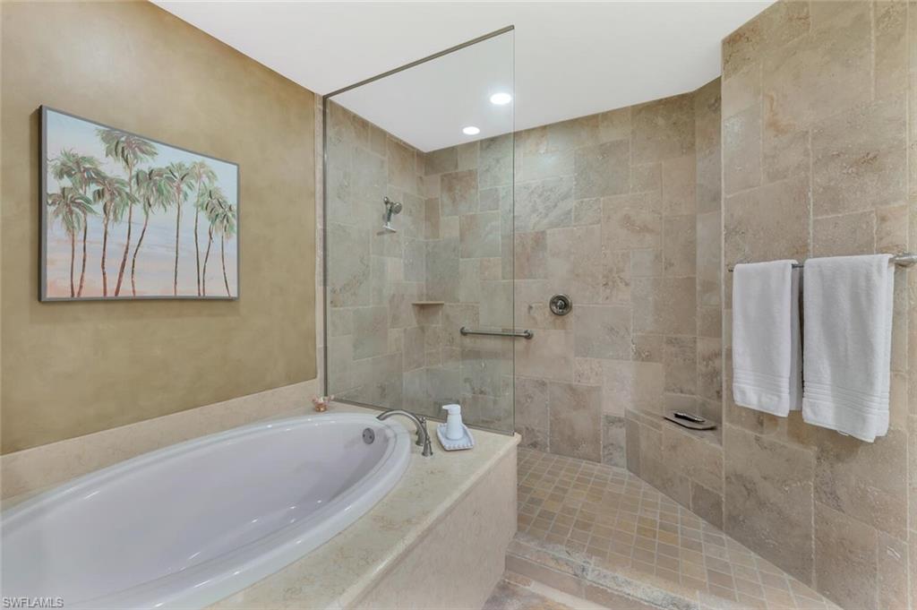 Giant shower with hand rail & bench.