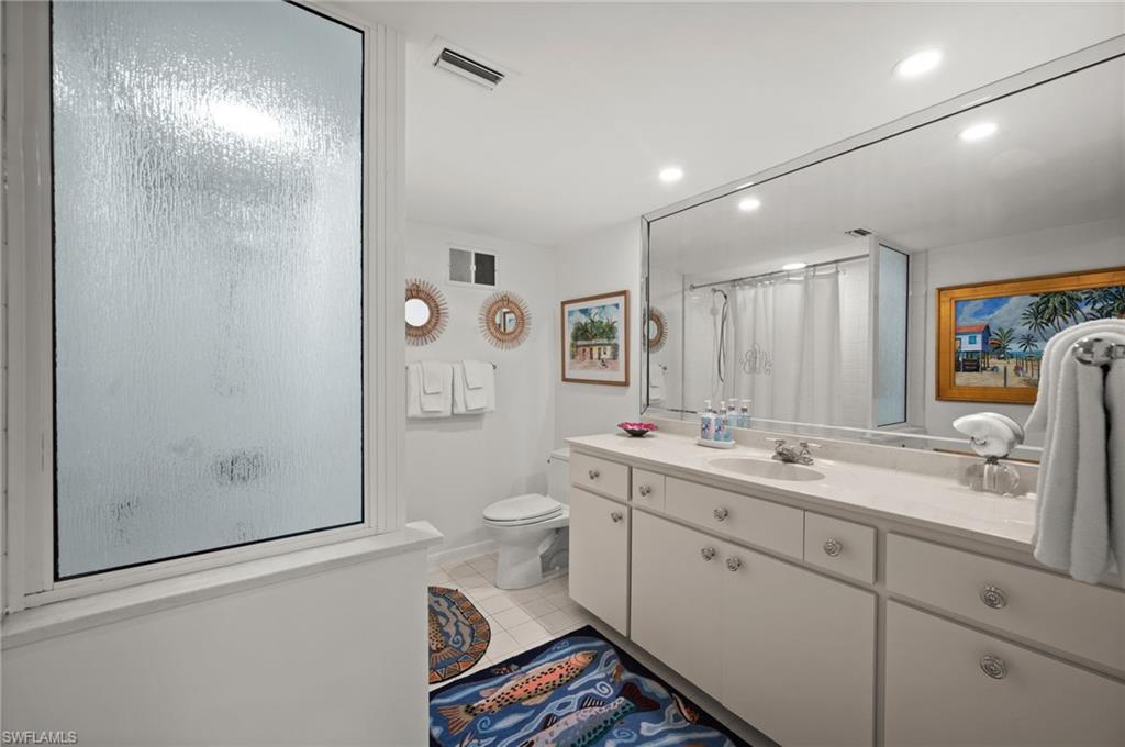Guest bedroom 2's en-suite bathroom has a cast iron tub with shower, an oversized single sink vanity and mirror as well as a separate linen closet!