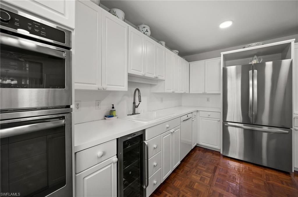 The stainless steel appliances include a French Door refrigerator/freezer with filtered water and ice maker, double ovens and microwave, wine cooler, cast iron white sink and an electric glass cooktop!