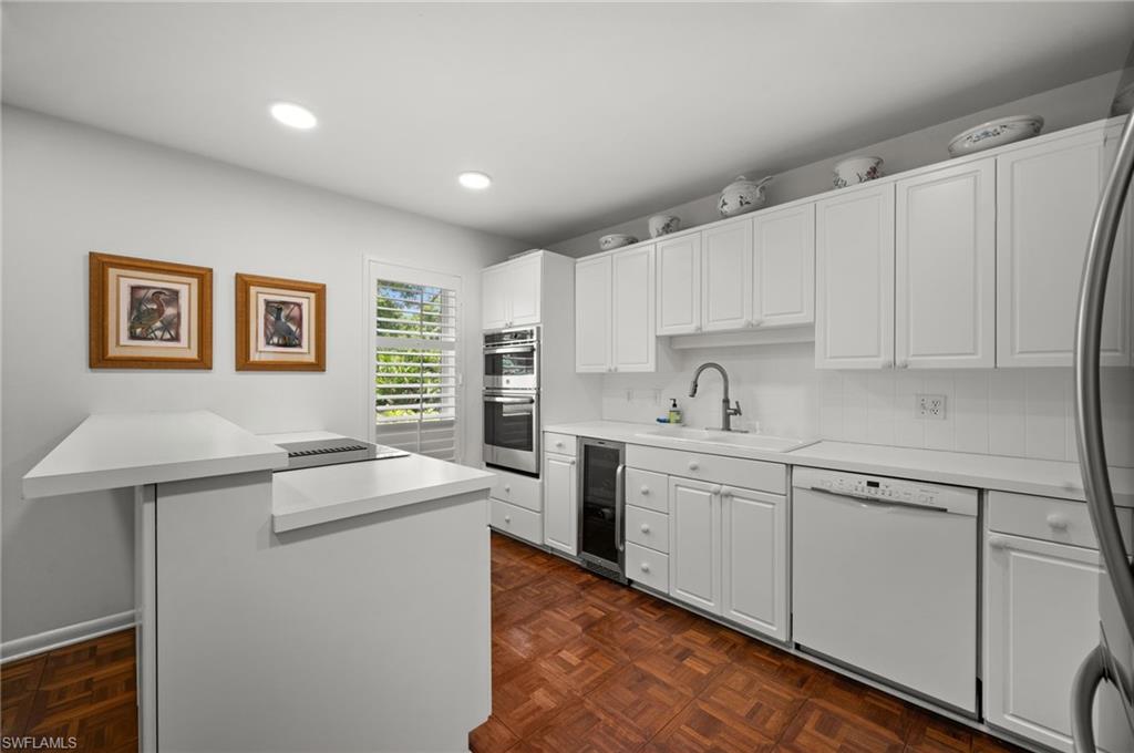 The all-white kitchen is great for entertaining and daily meal prep while close enough to the rest of the action!