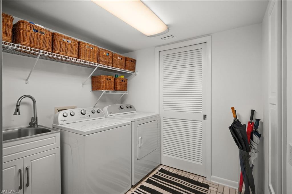 Washroom featuring independent washer,  dryer and sink seperated by a lovered poclet door  for the mechanicals!