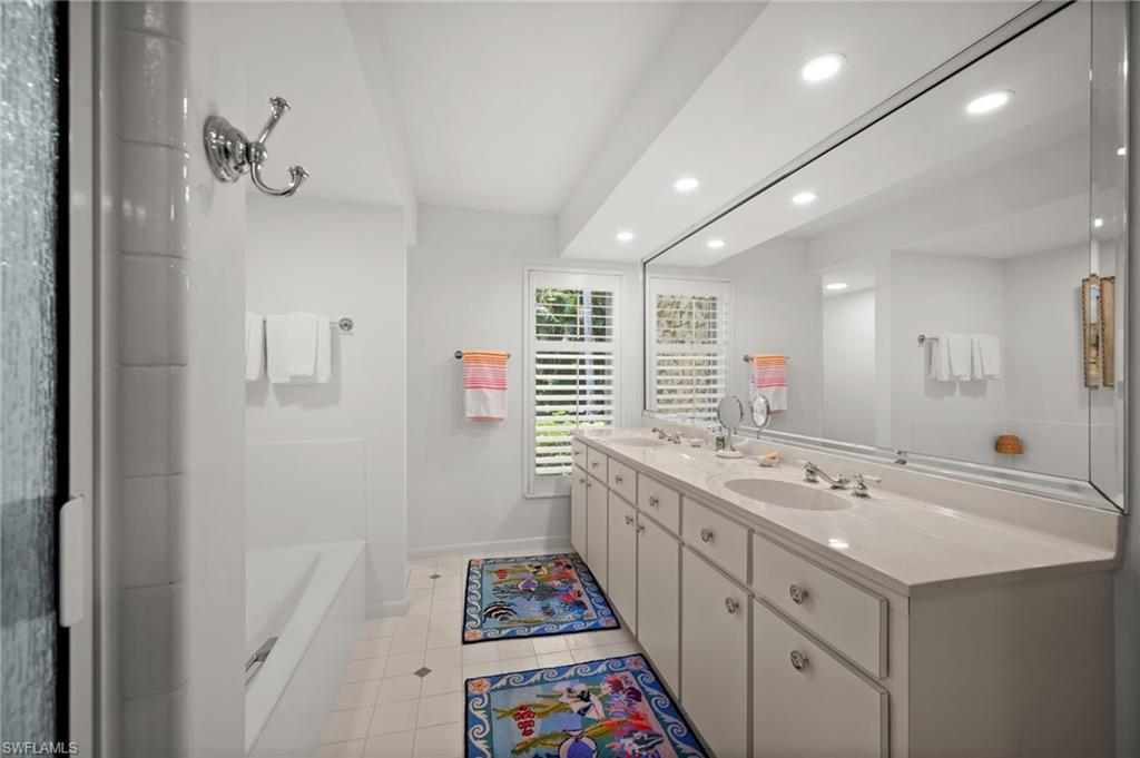 The light filled primary bathroom has a cast-iron soaking tub, separate shower and toilet areas, as well as a double sink vanity with plenty of storage!