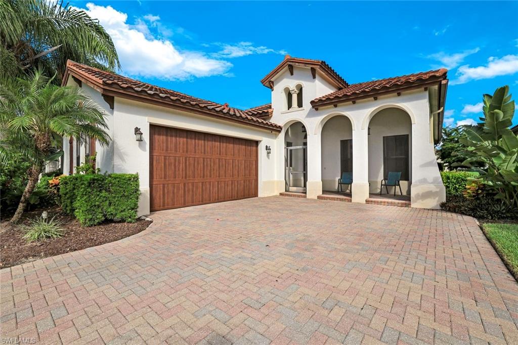 Mediterranean / spanish home featuring stucco siding, an attached garage, decorative driveway, and a tile roof