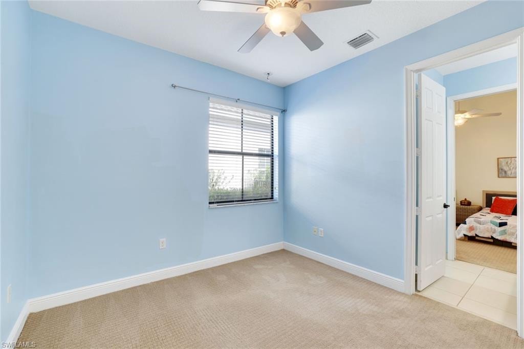 Spare room with carpet flooring and ceiling fan