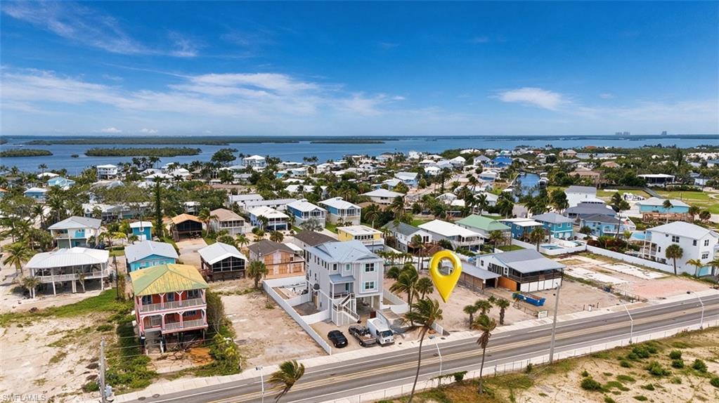 VIRTUALLY ENHANCED - Aerial perspective showcasing a coastal community with bay access